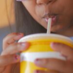 Young girl drinking a soft drink