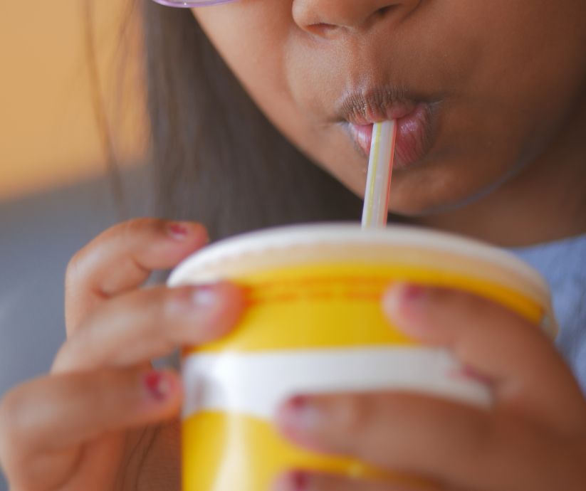 Young girl drinking a soft drink