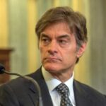 Dr Oz sits in front of microphone in 2014