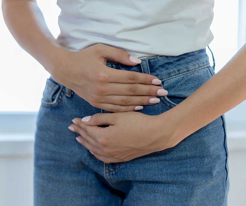 woman with cramps holding her lower abdomen