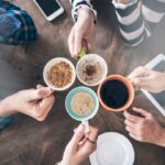 Group clinking coffee mugs together