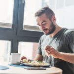 man eating at table