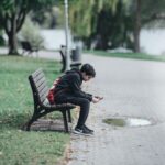 teenager sitting on a bench